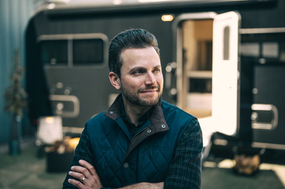 Brian Fuente in front of a Coast travel trailer